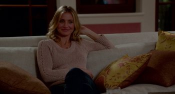 Movie still from “Sex Tape” (2014), directed by Jake Kasdan – A woman sitting on top of a white couch; Medium shot, Over the shoulder angle