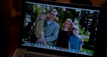Movie still from “Sex Tape” (2014), directed by Jake Kasdan – A laptop with a picture of a man and two children; Extreme Close Up shot, High angle