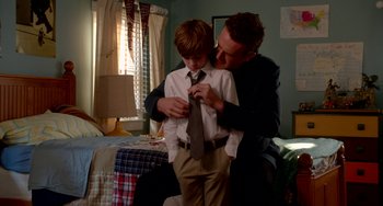 Movie still from “Sex Tape” (2014), directed by Jake Kasdan – A man helping a boy put on a tie; Medium shot, Over the shoulder angle