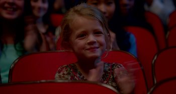 Movie still from “Sex Tape” (2014), directed by Jake Kasdan – A little girl sitting in a red chair in a theater; Close Up shot, High angle