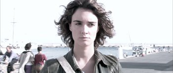 Movie still from “Sex and Lucía” (2001), directed by Julio Medem – A woman with long brown hair wearing a leather jacket; Close Up shot, Low angle