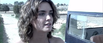 Movie still from “Sex and Lucía” (2001), directed by Julio Medem – A person near a car; Close Up shot, Over the shoulder angle