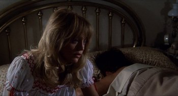 Movie still from “Shampoo” (1975), directed by Hal Ashby – A woman sitting on a bed next to a man sleeping; Close Up shot, Over the shoulder angle
