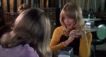 Movie still from “Shampoo” (1975), directed by Hal Ashby – A woman sitting in front of a mirror talking to another woman; Close Up shot, Over the shoulder angle