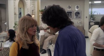 Movie still from “Shampoo” (1975), directed by Hal Ashby – A woman and a man are talking in a room; Medium shot, Over the shoulder angle