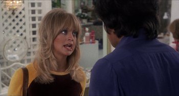Movie still from “Shampoo” (1975), directed by Hal Ashby – A woman with blonde hair talking to a man in a blue shirt; Close Up shot, Over the shoulder angle