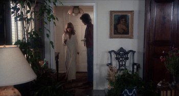 Movie still from “Shampoo” (1975), directed by Hal Ashby – Two people standing in front of a door; Wide shot, Over the shoulder angle