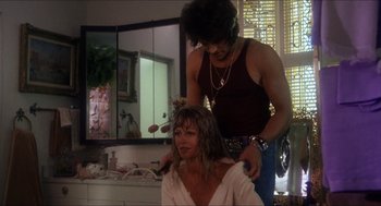Movie still from “Shampoo” (1975), directed by Hal Ashby – A woman getting her hair done by a man; Medium shot, Over the shoulder angle