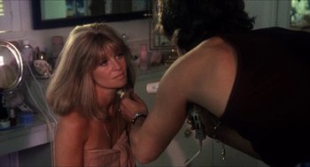 Movie still from “Shampoo” (1975), directed by Hal Ashby – A woman getting her hair done by a stylist; Close Up shot, Over the shoulder angle