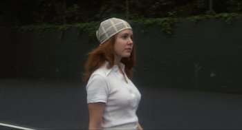 Movie still from “Shampoo” (1975), directed by Hal Ashby – A woman wearing a hat walking down a street; Medium shot, Low angle