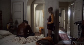 Movie still from “Shampoo” (1975), directed by Hal Ashby – A woman standing in front of a man in a room; Wide shot, High angle