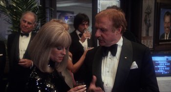 Movie still from “Shampoo” (1975), directed by Hal Ashby – A man and a woman are talking to each other; Medium shot, Over the shoulder angle