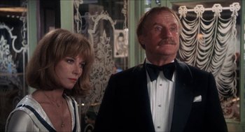 Movie still from “Shampoo” (1975), directed by Hal Ashby – A man and a woman standing next to each other in a room; Close Up shot, Low angle