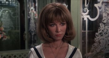 Movie still from “Shampoo” (1975), directed by Hal Ashby – A person wearing a dress; Close Up shot, Over the shoulder angle