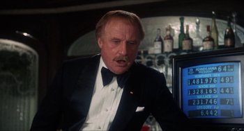 Movie still from “Shampoo” (1975), directed by Hal Ashby – An older man in a suit and bow tie in front of a bar; Close Up shot, Low angle