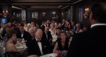 Movie still from “Shampoo” (1975), directed by Hal Ashby – A group of people sitting at a dinner table; Wide shot, Over the shoulder angle