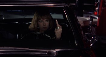 Movie still from “Shampoo” (1975), directed by Hal Ashby – A woman sitting in the drivers seat of a car at night; Medium shot, Over the shoulder angle