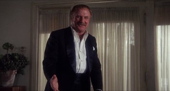 Movie still from “Shampoo” (1975), directed by Hal Ashby – An older man wearing a suit and tie; Medium shot, Low angle