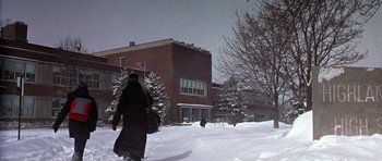 Movie still from “Shattered Glass” (2003), directed by Billy Ray – A person walking in the snow near a building; Extreme Wide shot, Low angle