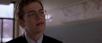Movie still from “Shattered Glass” (2003), directed by Billy Ray – A young man wearing glasses and a suit and tie; Close Up shot, Low angle