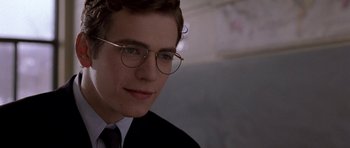 Movie still from “Shattered Glass” (2003), directed by Billy Ray – A young man wearing glasses and a suit and tie; Close Up shot, Over the shoulder angle