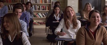 Movie still from “Shattered Glass” (2003), directed by Billy Ray – A group of people sitting at a table in a room; Medium shot, Low angle