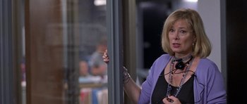 Movie still from “Shattered Glass” (2003), directed by Billy Ray – A woman standing next to a window holding a cigarette; Close Up shot, Over the shoulder angle