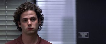 Movie still from “Shattered Glass” (2003), directed by Billy Ray – A person with curly hair; Close Up shot, Low angle