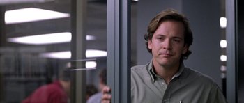 Movie still from “Shattered Glass” (2003), directed by Billy Ray – A man standing next to a glass door; Close Up shot, Over the shoulder angle