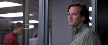 Movie still from “Shattered Glass” (2003), directed by Billy Ray – A man standing next to a window in a room; Close Up shot, Over the shoulder angle