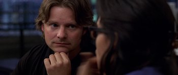 Movie still from “Shattered Glass” (2003), directed by Billy Ray – A man looking at a woman in the mirror; Close Up shot, Over the shoulder angle