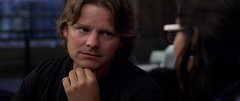 Movie still from “Shattered Glass” (2003), directed by Billy Ray – A person with his hand under his chin; Close Up shot, Over the shoulder angle