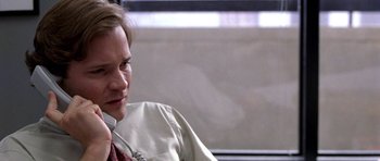 Movie still from “Shattered Glass” (2003), directed by Billy Ray – A man sitting on a bus talking on the phone; Close Up shot, Over the shoulder angle