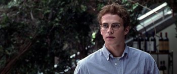 Movie still from “Shattered Glass” (2003), directed by Billy Ray – A young man wearing glasses and a blue shirt; Close Up shot, Over the shoulder angle
