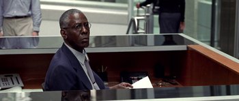 Movie still from “Shattered Glass” (2003), directed by Billy Ray – A man sitting at a desk in front of a laptop computer; Close Up shot, Low angle