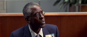 Movie still from “Shattered Glass” (2003), directed by Billy Ray – An older man wearing a suit and tie; Close Up shot, Over the shoulder angle