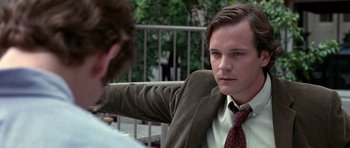 Movie still from “Shattered Glass” (2003), directed by Billy Ray – A man in a suit and tie sitting next to another man in a suit; Close Up shot, Over the shoulder angle
