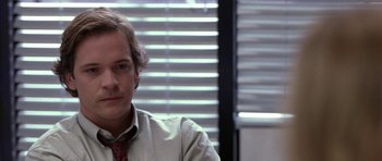 Movie still from “Shattered Glass” (2003), directed by Billy Ray – A man in a white dress shirt and red tie; Close Up shot, Over the shoulder angle