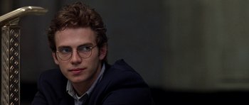 Movie still from “Shattered Glass” (2003), directed by Billy Ray – A young man wearing glasses and a jacket; Close Up shot, Over the shoulder angle