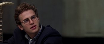 Movie still from “Shattered Glass” (2003), directed by Billy Ray – A young man wearing glasses sitting in a room; Close Up shot, Over the shoulder angle