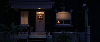 Movie still from “Shattered Glass” (2003), directed by Billy Ray – A night time picture of the front door of a house; Wide shot, High angle