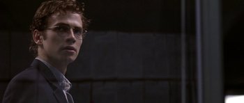 Movie still from “Shattered Glass” (2003), directed by Billy Ray – A young man wearing glasses standing in front of a brick wall; Close Up shot, Low angle