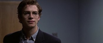 Movie still from “Shattered Glass” (2003), directed by Billy Ray – A young man wearing glasses and a suit; Close Up shot, Over the shoulder angle