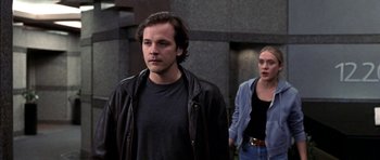 Movie still from “Shattered Glass” (2003), directed by Billy Ray – A man and a woman walking down a street; Medium shot, Low angle