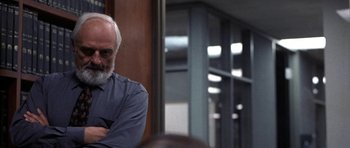 Movie still from “Shattered Glass” (2003), directed by Billy Ray – An older man with a gray beard sitting in front of a mirror; Medium shot, Over the shoulder angle