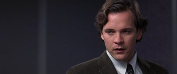 Movie still from “Shattered Glass” (2003), directed by Billy Ray – A person wearing a suit and tie; Close Up shot, Over the shoulder angle