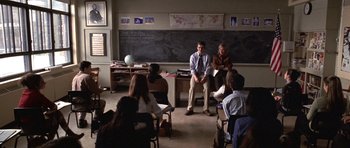 Movie still from “Shattered Glass” (2003), directed by Billy Ray – A group of people sitting in front of chalkboards; Wide shot, High angle