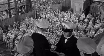 Movie still from “Ship of Fools” (1965), directed by Stanley Kramer – A black and white photo of a crowd of people; Wide shot, High angle