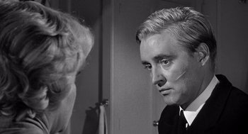 Movie still from “Ship of Fools” (1965), directed by Stanley Kramer – A black - and - white photo of a man looking at himself in the mirror; Close Up shot, Over the shoulder angle