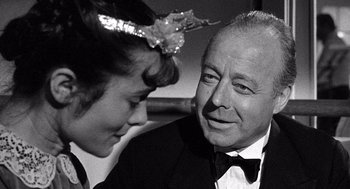 Movie still from “Ship of Fools” (1965), directed by Stanley Kramer – An older man and a young woman in formal wear; Close Up shot, Over the shoulder angle